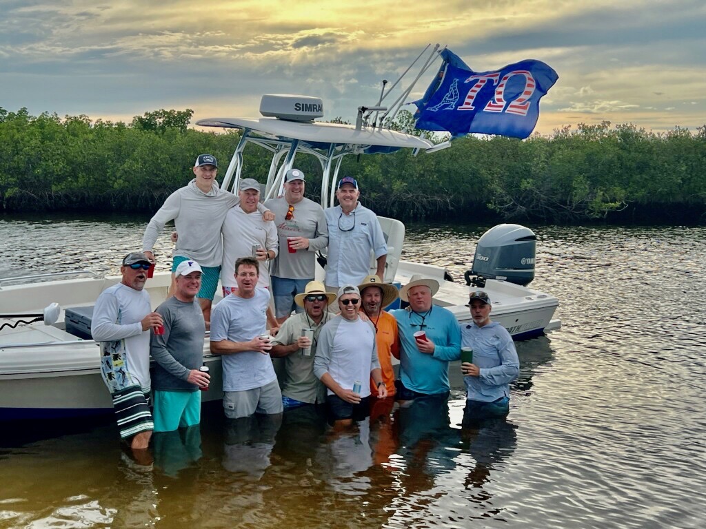 ATO alumni boating with the ATO flag flying
